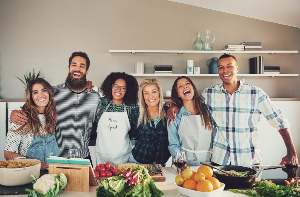 group of six adults at food preparation table